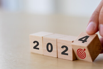 2024 goals of business or life. Wooden cubes with 2024 and goal icon on smart background. Starting...