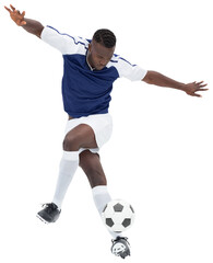 Digital png photo of african american male soccer player kicking ball on transparent background