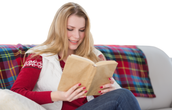 Digital png photo of happy caucasian woman reading book on couch on transparent background - Powered by Adobe