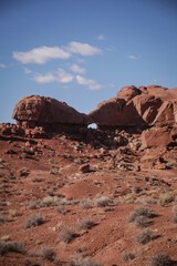 Natural arch formation in red sandstone rock formatons in utah desert