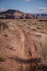 Dirt bike trail through Moab Utah in desert landscape with red sandstone buttes