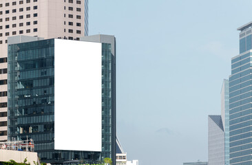 Mock up white large LED display vertical billboard on tower building .clipping path for mockup