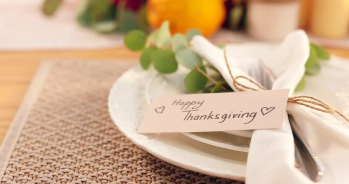 Thanksgiving, dinner and festive table for fine dining with plate, card and note to welcome guest. Happy, event and setting for party, celebration or catering for meal in home, house or apartment