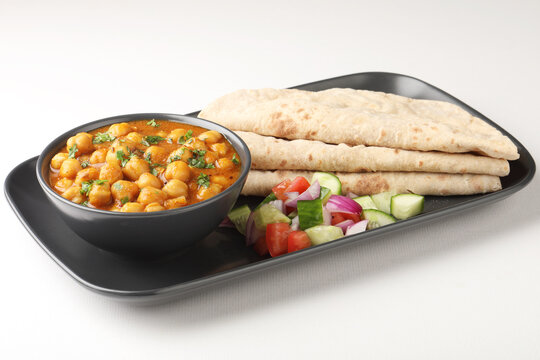 Indian vegetarian food - homemade fresh chapati served with vegetable stew and chickpeas curry 