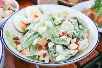 caesar salad or vegetable salad with bacon , egg and Bread Croutons