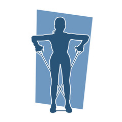 Silhouette of a woman doing aerobic move. Silhouette of a gym sporty person doing workout with pull rope.