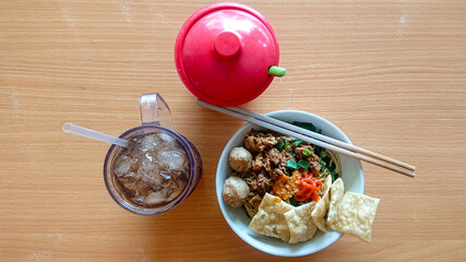 street food meatball chicken noodle with sweet iced tea drink and red chili sauce
