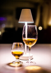 Glasses of white wine and cognac are on the table in the restaurant
