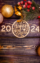 Happy new year 2024 on wooden brown background
