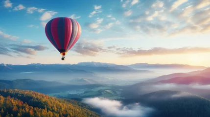 Poster Hot air balloon flying over the valley at sunrise. © red_orange_stock