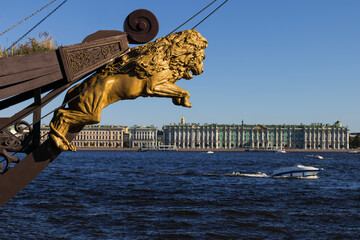 golden lion against the backdrop of the Neva River and the Winter Palace in St. Petersburg