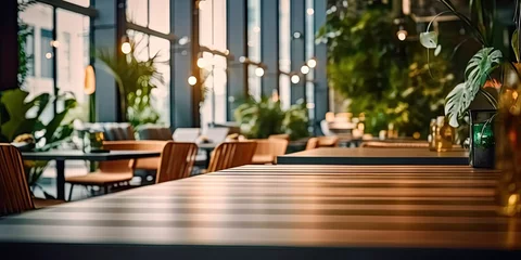 Fotobehang Contemporary dining experience. Modern wooden table and chairs set in stylish and elegant restaurant interior. Urban elegance. Empty desk and chair in interior with beautiful design and ambiance © Bussakon
