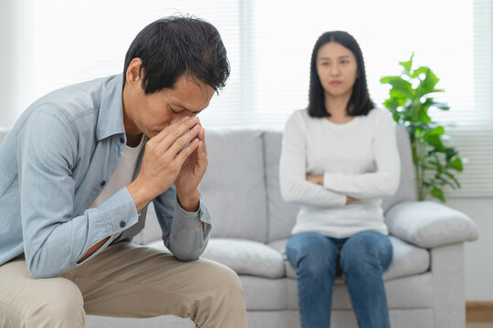 Family divorce problem concept, Husband and wife sitting separating after arguing in the living room at home.