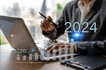 Businessman with a modern visual screen 2024 global network connection Graph analyzing financial growth and business planning concept