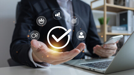 Businessman use laptop and virtual correct sign or tick mark,  hand shows sign of top service Quality assurance, service experience, show the standards of products.