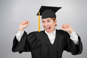 Caucasian woman dancing in graduation gown on white background. 
