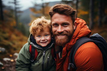 cheerful bearded man with redhead son looking at camera, happy family trip