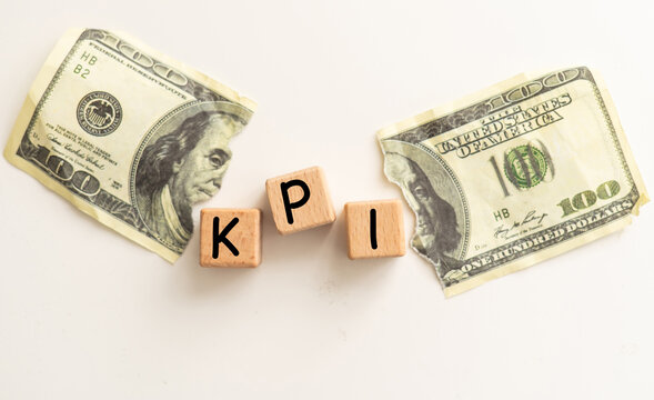 Concept word 'KPI' on cubes on a beautiful background from dollar bills.