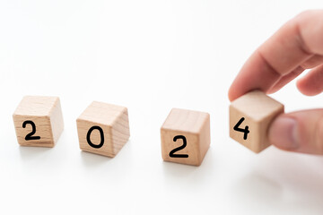 Hand translated wooden cube from 2023 to 2024. new business goal strategy concept.2023 goal...