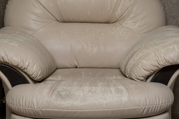 Defects on a white leather sofa. Damaged to leather furniture. Close up of damaged white leather...