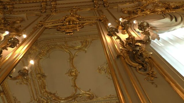 Interior of the palace is decorated with old mirrors and gilding. Vintage wall of the royal time.