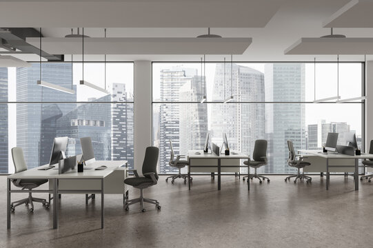 Modern office workspace interior with pc desktop and panoramic window