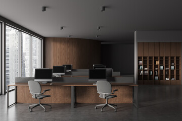 Modern office workplace interior with pc monitors on table, panoramic window