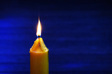 A Candle burning against for background.