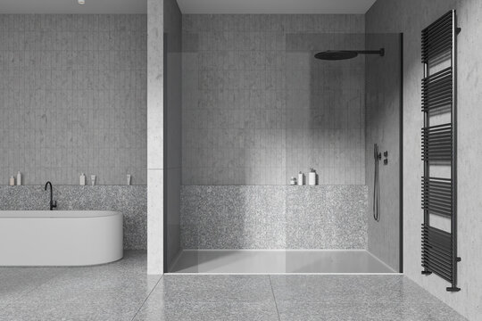 Grey home bathroom interior with shower and tub with rail, accessories