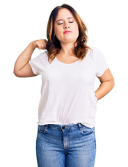 Young beautiful caucasian woman wearing casual white tshirt suffering of neck ache injury, touching neck with hand, muscular pain