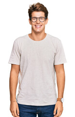 Handsome caucasian man wearing casual clothes and glasses with a happy and cool smile on face....
