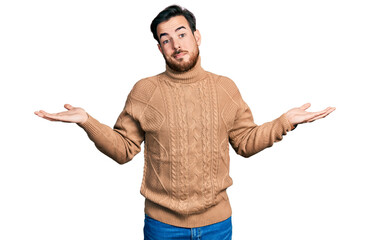 Young hispanic man wearing casual clothes clueless and confused expression with arms and hands raised. doubt concept.