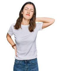 Obraz premium Young beautiful woman wearing casual white t shirt suffering of neck ache injury, touching neck with hand, muscular pain