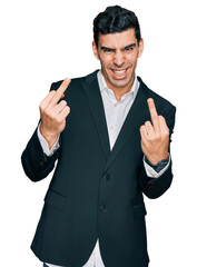 Handsome hispanic man wearing business clothes showing middle finger doing fuck you bad expression, provocation and rude attitude. screaming excited