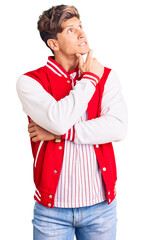 Young handsome man wearing baseball uniform thinking worried about a question, concerned and nervous with hand on chin