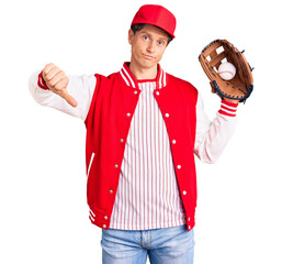 Young handsome man wearing baseball uniform holding golve and ball with angry face, negative sign...