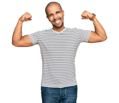 Hispanic adult man wearing casual clothes showing arms muscles smiling proud. fitness concept.