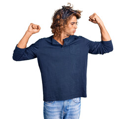 Young hispanic man wearing casual clothes showing arms muscles smiling proud. fitness concept.