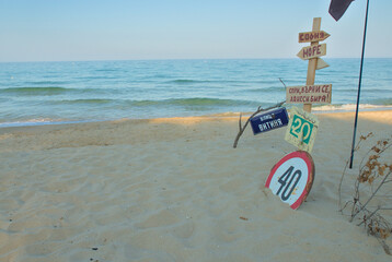 Funny creative signs collected on the beach by the sea. on the tables it is written: name of the street Vitinya, sea, Sofia and stop and bring a beer