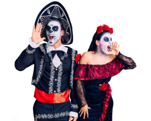 Young couple wearing mexican day of the dead costume over background shouting and screaming loud to side with hand on mouth. communication concept.