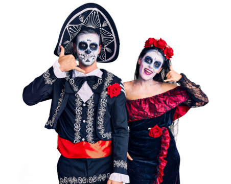 Young couple wearing mexican day of the dead costume over background smiling doing phone gesture with hand and fingers like talking on the telephone. communicating concepts.