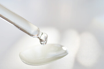 A transparent pipette of serum under the morning sun.