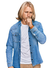 Caucasian man with blond long hair wearing casual denim jacket feeling unwell and coughing as symptom for cold or bronchitis. health care concept.