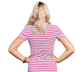 Young caucasian woman wearing casual clothes standing backwards looking away with arms on body