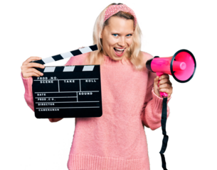 Young caucasian woman holding video film clapboard and megaphone smiling and laughing hard out loud because funny crazy joke.