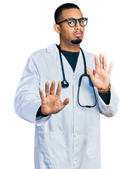 Young african american man wearing doctor uniform and stethoscope moving away hands palms showing...