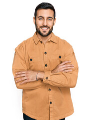 Young hispanic man wearing casual clothes happy face smiling with crossed arms looking at the camera. positive person.