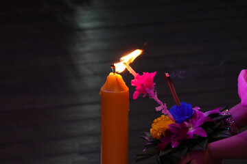 Hand lighting candle of Krathong to Celebrate Loy Krathong Day.