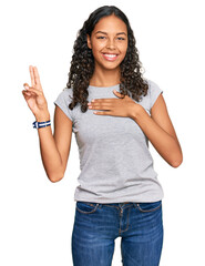 Young african american girl wearing casual clothes smiling swearing with hand on chest and fingers up, making a loyalty promise oath