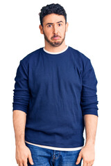 Fototapeta premium Young hispanic man wearing casual clothes depressed and worry for distress, crying angry and afraid. sad expression.